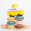 A Candylab wooden toy Citron Macaron van placed on a pile of macaron | Conscious Craft 